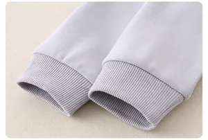 Close-up of ribbed cuffs on children's cotton sweater showing neat stitching