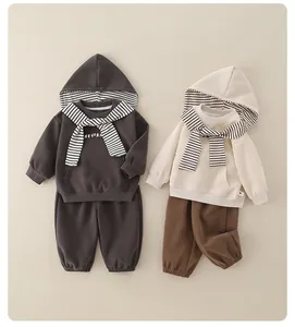 Flat lay of baby striped hooded sweatshirt sets in dark grey and beige colors