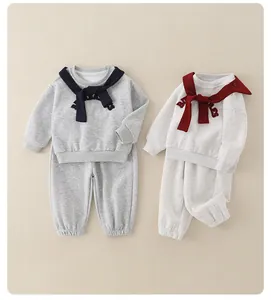 Detail of kids cotton sweatshirt set with letter embroidery and contrast neck wrap