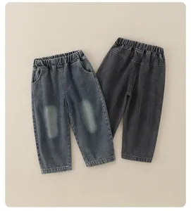 Detail view of boys denim pants showing elastic waistband and vintage washed texture