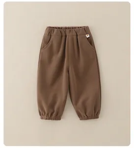 Detail of brown kids jogger pants with elastic waistband and soft knitted fabric