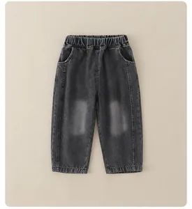 Close-up of boys' dark grey washed denim jeans featuring elastic waistband and whiskers