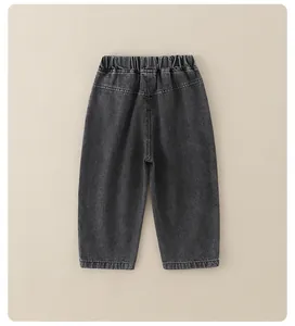 Detail view of boys' dark grey denim pants featuring elastic waist and washed texture