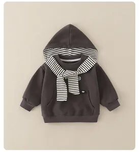 Detail of dark brown baby hoodie with striped scarf-like hood lining and kangaroo pocket