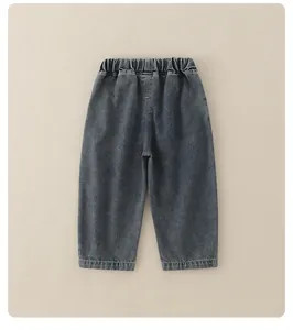 Detail view of boys dark grey washed denim jeans with an elastic waistband and soft texture