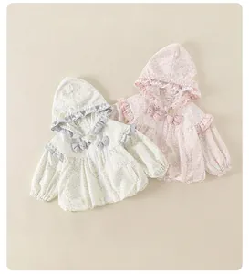 Detail of floral hooded jacket with ruffle trim and bow accents for toddler girls