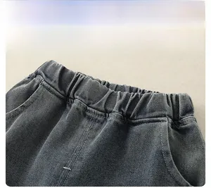 Detail view of boys' dark blue denim jeans featuring a comfortable elastic waistband and stitching