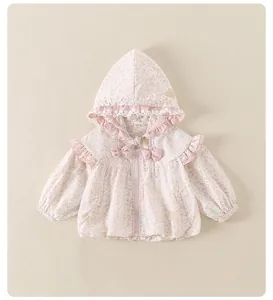 Close-up of pink floral baby hoodie with delicate lace ruffles and bow details