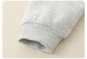 Close-up of ribbed knit cuffs on grey cotton sweatshirt for children with soft texture
