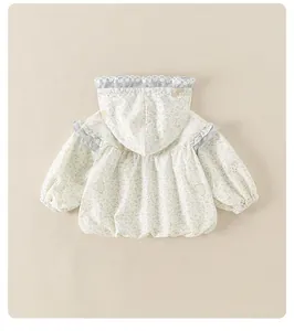 Detail of floral baby girl hooded jacket with lace embroidery and ruffle accents