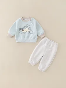 Tuta da neonato in cotone blu con simpatico ricamo a forma di dinosauro e maniche lunghe