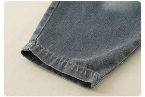Macro view of dark blue denim twill fabric with precise stitching and washed finish