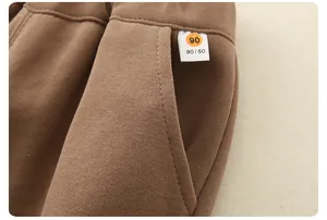 Detail of brown children's pants showing elastic waistband and stitching