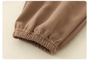 Detail of high-density brown knitted cotton fabric and elastic ribbed cuff stitching