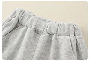 Detail of grey marl toddler joggers featuring a wide elasticated waistband and pocket