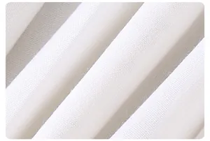 Macro shot of white woven fabric showing detailed fine texture and soft natural pleats