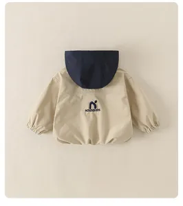 Dettaglio del ricamo del marchio sul retro della giacca a vento con cappuccio da ragazzo