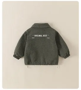 Detailed back view of children's green plaid jacket with stylish slogan prints