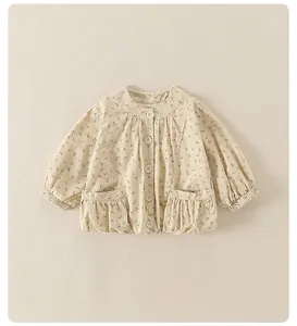 Close-up of baby floral cotton jacket featuring wood ear trim pockets and white buttons