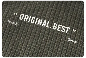 Macro shot of dark olive plaid woven fabric texture with white printed typography detail