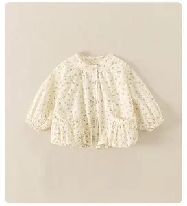Detail of baby girl floral cotton cardigan featuring ruffle pockets and elastic cuffs