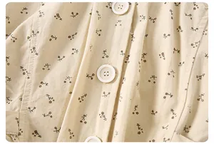 Close-up of baby floral cotton jacket with vintage buttons and detailed flower print