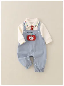 Detail of baby overalls set with apple pocket and colorful letter print on white shirt