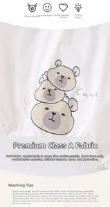 Detail of soft cotton baby outfit with cartoon bears and Class A fabric label