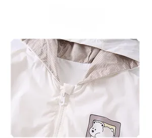 Detail of hooded jacket showing polar bear print, zipper, and plaid lining inside