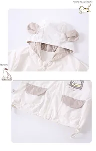 Close-up of boys cream hoodie jacket with bear ears and striped pocket details