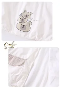 Detail of baby cream jacket with cute cartoon bear print and checkered flap pocket design
