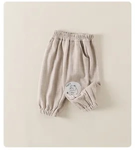 Close-up of elastic waistband and knit texture on beige toddler pants with cartoon patch