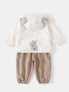 Cute toddler boy two-piece set featuring cream bear ear hoodie and brown jogger pants