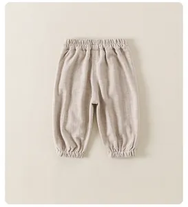 Close-up of beige striped baby trousers with elastic waistband and ribbed cuffs