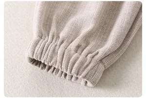Detailed macro view of the elastic ribbed cuffs on a beige knit infant sweater