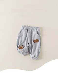Macro detail of toddler ribbed pants featuring elastic waist and cute cartoon patches