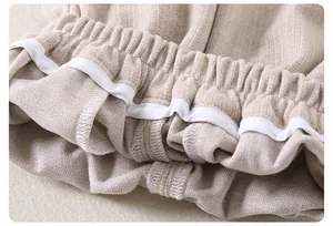 Close-up of beige baby pants showing high-quality elastic waistband and double-stitched seams