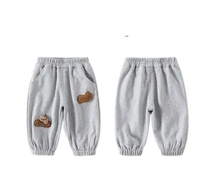 Front and back view of children's grey knit joggers with cartoon embroidery detail