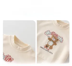 Detail of cream baby sweatshirt with ribbed neckline, shoulder buttons and plush bear motif