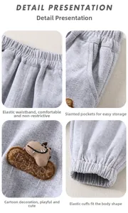 Detail view of boys gray knitted pants with elastic waist, pockets and dinosaur patch