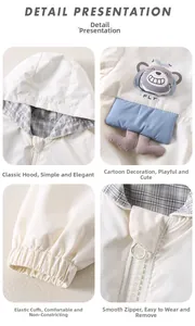 Detail view of toddler windbreaker with bear decor, plaid lining, and elastic cuffs