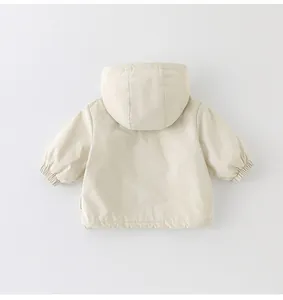 Rear view of cream hooded jacket for girls with drawstring hem and windproof fabric