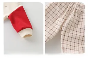 Detail of elastic ribbed cuffs and plaid trousers waist on cotton toddler boy outfit