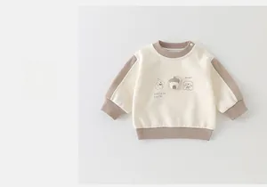 Detail of baby sweatshirt featuring cute cartoon puppy print and convenient shoulder snaps