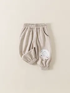 Infant casual joggers in beige corduroy with happy bear patch and elastic waist