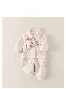 Detail of baby knit set featuring 3D cartoon puppy and printed BREAD and COFFEE motifs