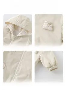 Detail of girls' cream hooded jacket with rabbit embroidery and ribbed cuffs