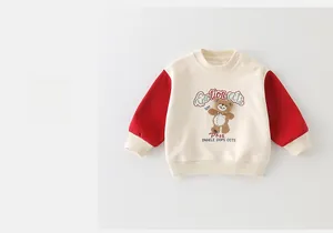 Detail of baby boy sweatshirt with red contrast sleeves and cute bear embroidery