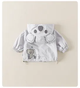 Detail of baby boy's grey koala jacket featuring cute 3D ears and cartoon back print
