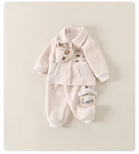 Close-up of beige toddler set featuring 3D bear decor and cute food illustrations